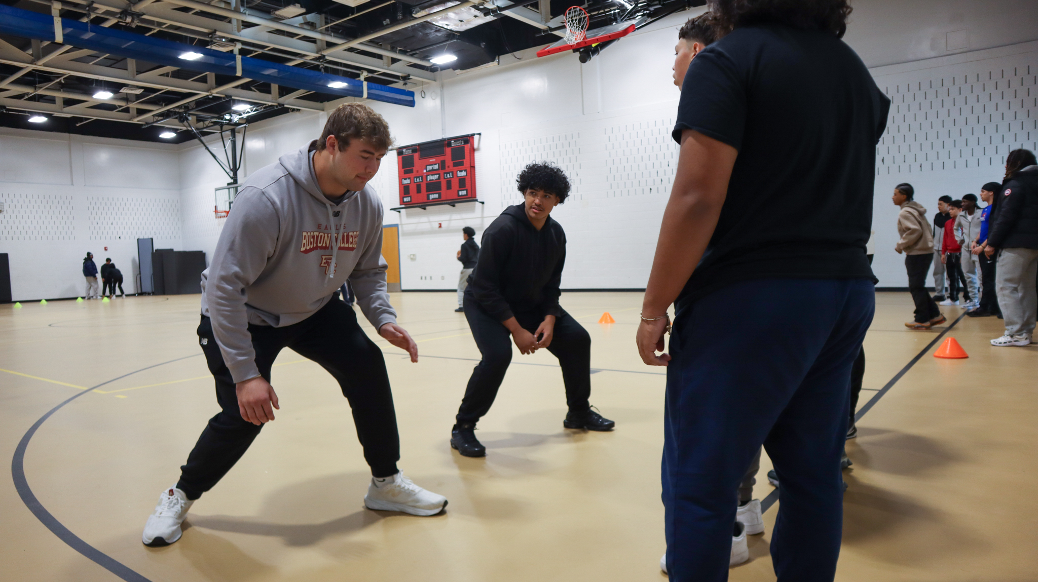 CHS football players working on their offensive line technique with BC lineman Ozzy Trapilo